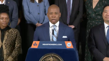 Photo of Eric Adams speaking at a podium
